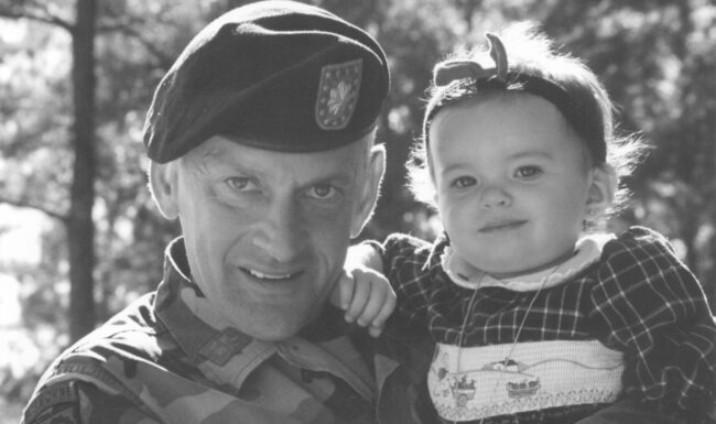 Gerald Malloy in uniform holding his Daughter